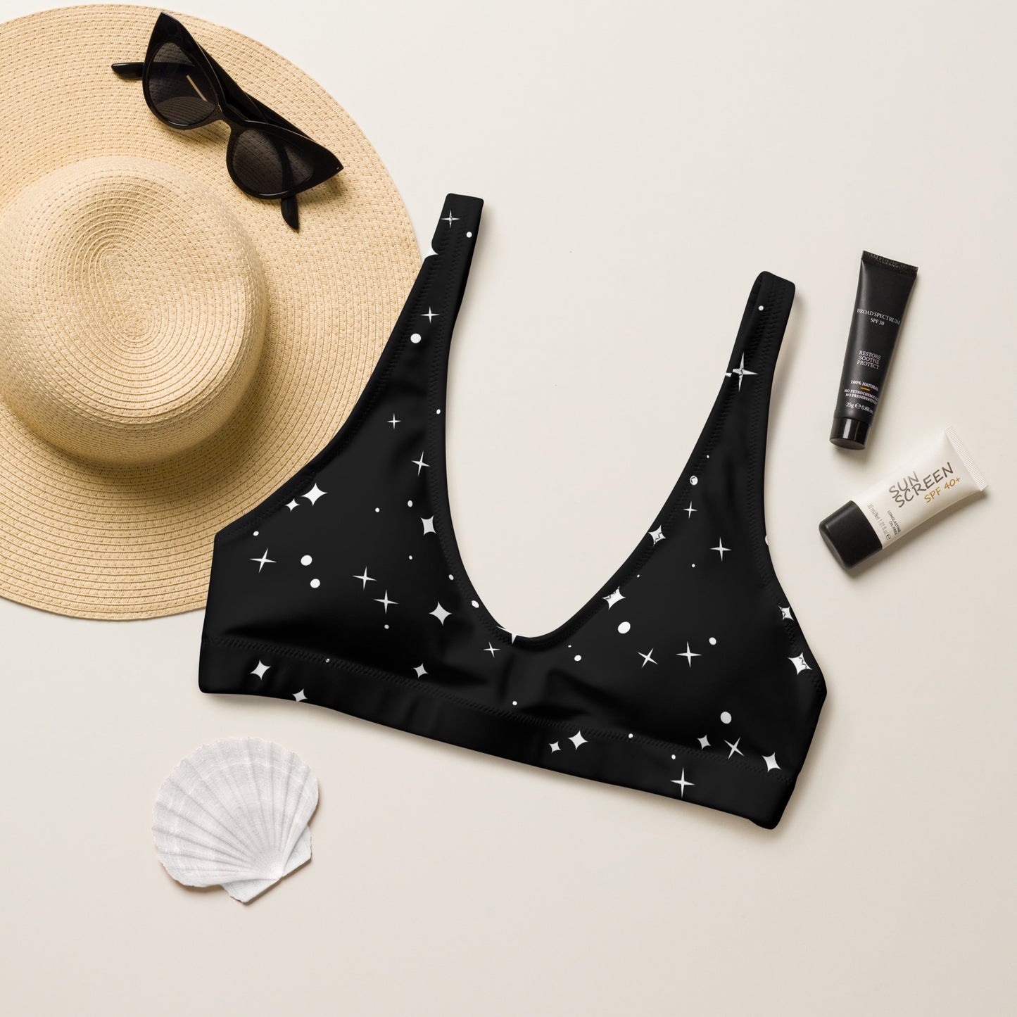 white stars on black bikini top with sun hat and accessories for mockup.