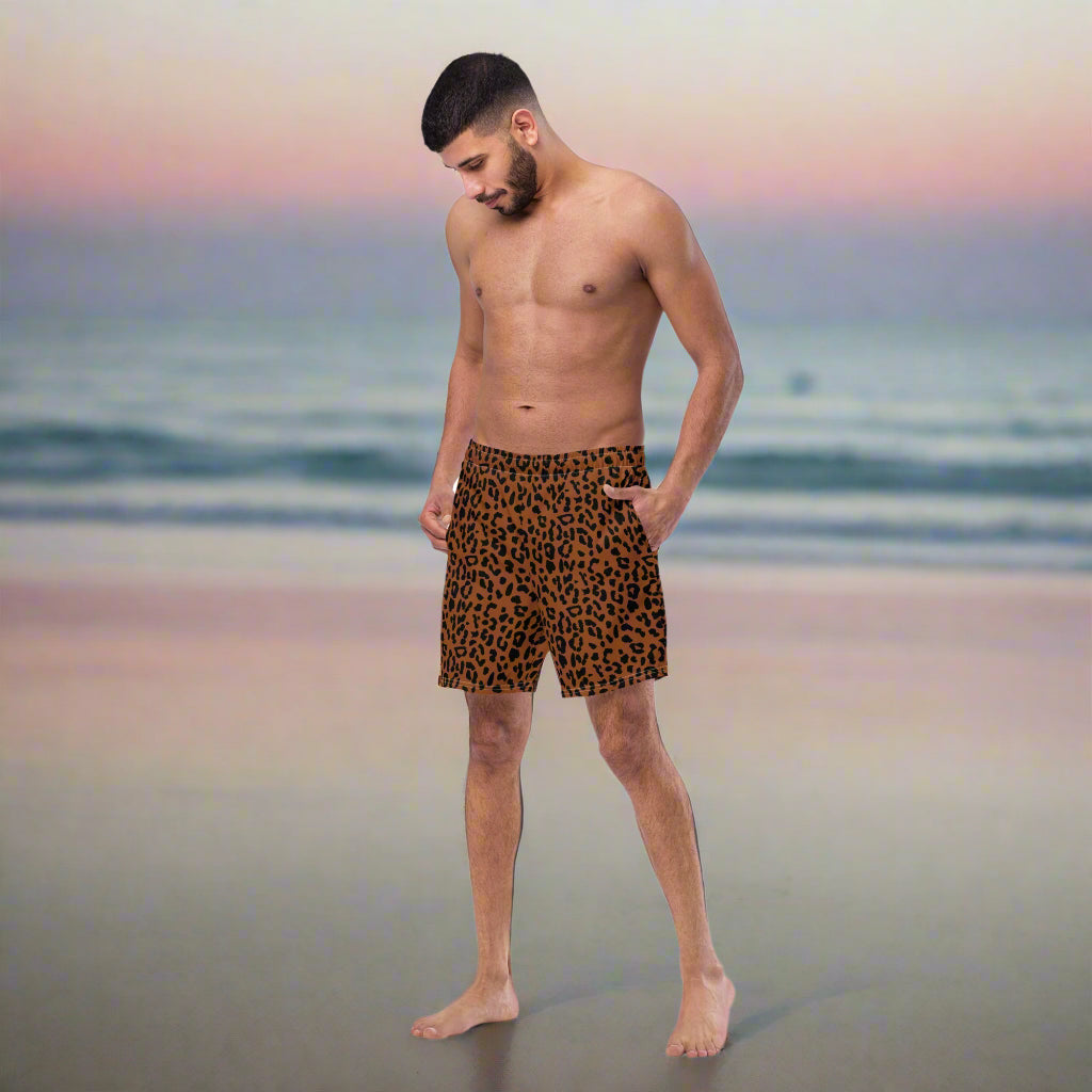 man wearing a brown black cheetah print swimsuit
