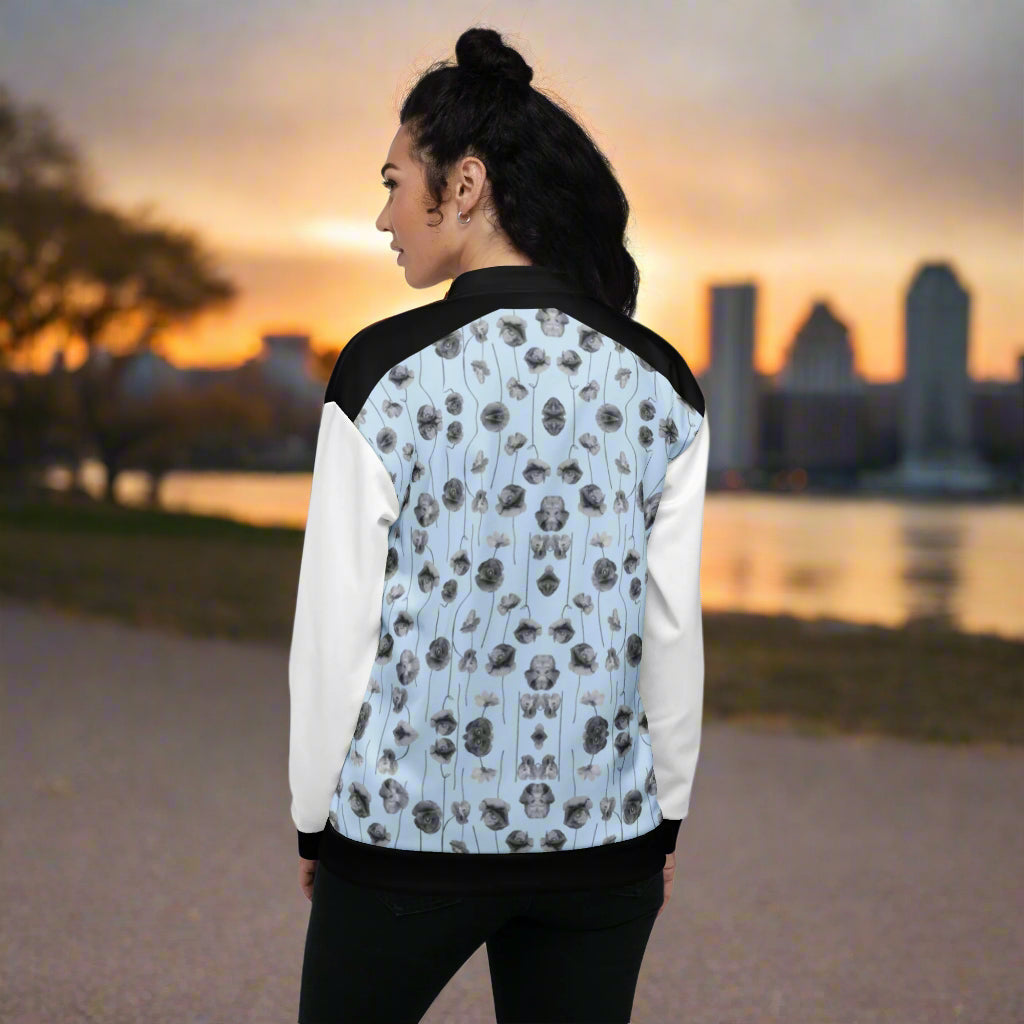 woman wearing a light blue, black and white jacket