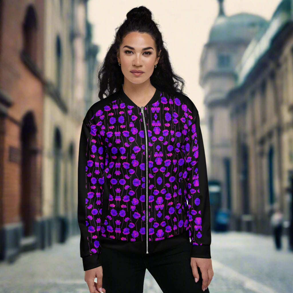 purple and black unisex bomber jacket on a woman standing on a street road.