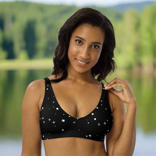 woman wearing a black bikini top with white stars. 