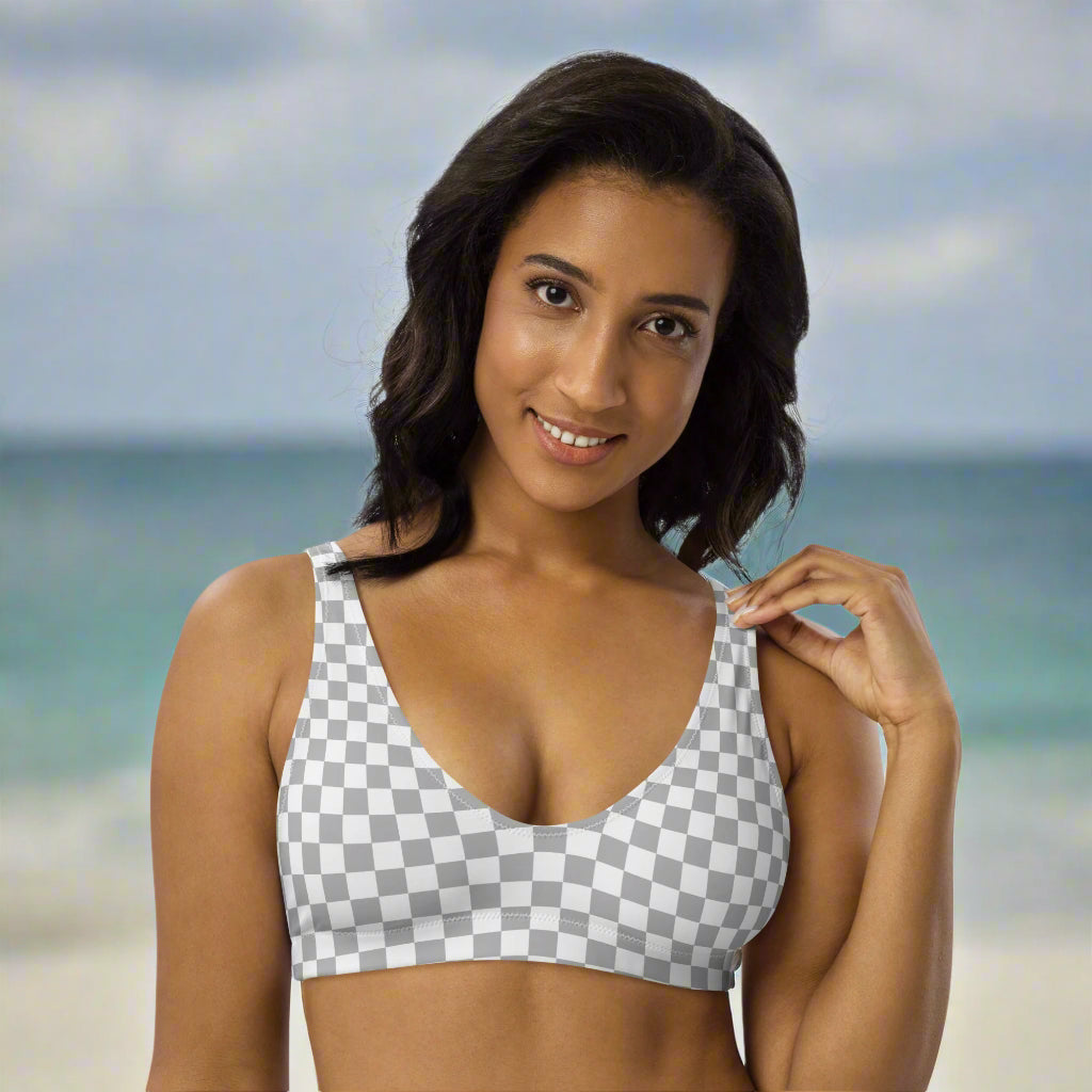 woman wearing a light grey and white bikini top