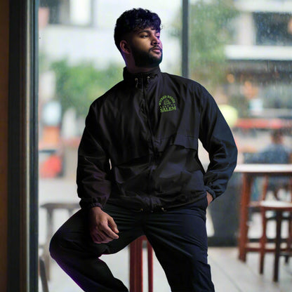 Windbreaker rain jacket with green wicked roads lead to Salem with a black cat riding a motorcycle on a stylish jacket