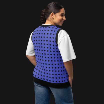 Woman wearing a blue heart patterned vest over a white shirt on a white background