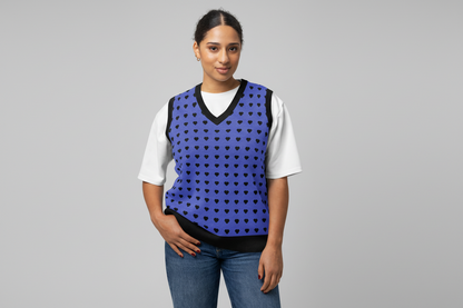 Woman wearing a blue vest with black heart patterns on a white background