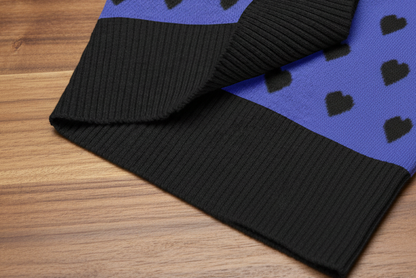 Close-up of a black and blue fabric with heart patterns on a white background